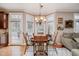 Sunlit dining room with a bay window, a stylish chandelier, and hardwood flooring at 10210 Governors Drive Dr, Chapel Hill, NC 27517
