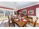Elegant dining room boasts a set table, a crystal chandelier, and window views at 10210 Governors Drive Dr, Chapel Hill, NC 27517