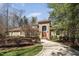 Beautiful brick home with well-manicured landscaping, long driveway, and red front door at 10210 Governors Drive Dr, Chapel Hill, NC 27517