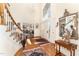 Welcoming foyer with hardwood floors, elegant stairway, and charming decor elements at 10210 Governors Drive Dr, Chapel Hill, NC 27517