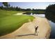 Scenic golf course with a golfer hitting from a sand trap next to a water feature at 10210 Governors Drive Dr, Chapel Hill, NC 27517
