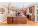 Spacious kitchen with a large center island, custom cabinets, granite countertops and pot racks at 10210 Governors Drive Dr, Chapel Hill, NC 27517