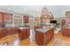 Gourmet kitchen with granite countertops, dual islands, and hanging pot rack at 10210 Governors Drive Dr, Chapel Hill, NC 27517