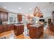 Gourmet kitchen with granite countertops, dual islands, and hanging pot rack at 10210 Governors Drive Dr, Chapel Hill, NC 27517