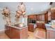 Gourmet kitchen with custom cabinets, granite countertops, hardwood floors and a copper pot rack at 10210 Governors Drive Dr, Chapel Hill, NC 27517