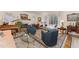 Elegant living room with a fireplace, piano, and plenty of seating at 10210 Governors Drive Dr, Chapel Hill, NC 27517
