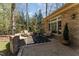 Relaxing outdoor patio with comfortable seating and a brick retaining wall at 10210 Governors Drive Dr, Chapel Hill, NC 27517