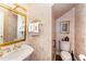 Charming powder room featuring detailed wallpaper, gold fixtures, and a classic vanity at 10210 Governors Drive Dr, Chapel Hill, NC 27517