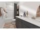 A modern bathroom featuring a double vanity, a large mirror, and a shower/tub combo at 103 Ailey Brook Way # 200, Wake Forest, NC 27587
