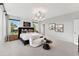 Inviting bedroom featuring a well-lit room with a king bed, chaise lounge, and ample natural light from multiple windows at 103 Ailey Brook Way # 200, Wake Forest, NC 27587