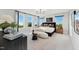 Sunlit bedroom with large windows, a comfy king bed, and a stylish chaise lounge for relaxing and reading at 103 Ailey Brook Way # 200, Wake Forest, NC 27587