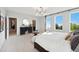 Airy bedroom boasting a king bed, sitting area, and bright natural light streaming through the multiple windows at 103 Ailey Brook Way # 200, Wake Forest, NC 27587