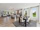 Open-concept kitchen with stainless steel appliances and a large dining room area with modern decor at 103 Ailey Brook Way # 200, Wake Forest, NC 27587