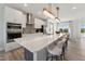 Open concept kitchen features an eat-in island with white cabinets and stainless steel appliances at 103 Ailey Brook Way # 200, Wake Forest, NC 27587