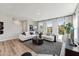 Inviting living room with hardwood floors, neutral tones, and large windows overlooking green space at 103 Ailey Brook Way # 200, Wake Forest, NC 27587