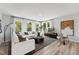 Bright living room with large windows, hardwood floors and modern decor at 103 Ailey Brook Way # 200, Wake Forest, NC 27587