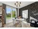 Bright office with a modern light fixture, black and white accent wall, and a large window with a view of the green outdoors at 103 Ailey Brook Way # 200, Wake Forest, NC 27587