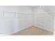 Spacious walk-in closet with neutral carpet, and ample shelving for organized storage of clothing and accessories at 103 Ailey Brook Way # 200, Wake Forest, NC 27587