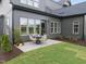 Cozy backyard featuring a patio with outdoor dining set, lush green grass, and mature landscaping at 1049 Coldspring Circle, Durham, NC 27705