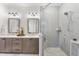 Beautiful bathroom featuring double vanities and a glass enclosed shower with light gray tiling and tiled flooring at 1049 Coldspring Circle, Durham, NC 27705