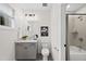 Well-lit bathroom with a vanity, toilet, shower-tub combo, and neutral tiling throughout at 1049 Coldspring Circle, Durham, NC 27705