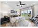 Serene bedroom with a large bed, soft lighting, and a view of the outdoors at 1049 Coldspring Circle, Durham, NC 27705