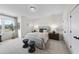 Well-lit bedroom features neutral colors, carpet flooring, two dressers, and large windows with a view at 1049 Coldspring Circle, Durham, NC 27705