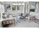 Cozy living room with comfortable seating, large windows, and a modern fireplace at 1049 Coldspring Circle, Durham, NC 27705