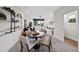 Open-concept living room and dining area features a round table, comfortable seating, and large windows at 1049 Coldspring Circle, Durham, NC 27705
