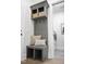 Mud room with built-in bench, storage cubbies, hooks, throw pillows, and laundry area at 1049 Coldspring Circle, Durham, NC 27705