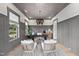 Bright home office with patterned wallpaper, modern lighting, and comfortable seating at 1049 Coldspring Circle, Durham, NC 27705