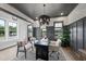 Sophisticated home office featuring a modern desk, stylish chandelier, and walls accented with wainscoting at 1049 Coldspring Circle, Durham, NC 27705