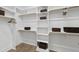 Bright walk-in closet with an organization system featuring shelves, clothes rods, and decorative storage baskets at 1049 Coldspring Circle, Durham, NC 27705