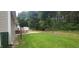 Spacious backyard featuring a patio, deck, and ample space for outdoor activities and relaxation at 107 Oak Park Dr, Benson, NC 27504