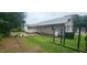 Large backyard featuring a wooden deck, a stone picnic table, and a well maintained yard at 107 Oak Park Dr, Benson, NC 27504