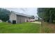 Spacious backyard with a patio, deck, and lush green lawn, perfect for outdoor activities at 107 Oak Park Dr, Benson, NC 27504