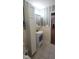 This bathroom features a vanity with sink, linen closet, and striped wall paper at 107 Oak Park Dr, Benson, NC 27504