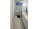 Bathroom featuring walk-in tub, white cabinets, and neutral tile flooring at 107 Oak Park Dr, Benson, NC 27504