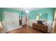 Cozy bedroom featuring a wooden floor, closet, and chest of drawers with a mirror at 107 Oak Park Dr, Benson, NC 27504