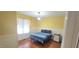 Cozy bedroom featuring natural light from a window and light yellow walls at 107 Oak Park Dr, Benson, NC 27504