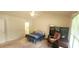 Bright bedroom with a bed, desk, and a view leading into the bathroom at 107 Oak Park Dr, Benson, NC 27504