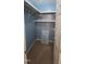 Cozy walk-in closet with shelving and blue accents at 107 Oak Park Dr, Benson, NC 27504