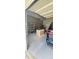 Garage includes workspace, storage shelves, and blue minivan at 107 Oak Park Dr, Benson, NC 27504