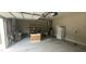 The garage space includes a refrigerator, shelving, and work area at 107 Oak Park Dr, Benson, NC 27504