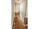 Hallway featuring wood floors, a closet, and wood paneled wainscoting at 107 Oak Park Dr, Benson, NC 27504