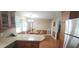 Eat-in kitchen with wood cabinets, laminate countertops, and stainless-steel appliances at 107 Oak Park Dr, Benson, NC 27504