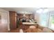 Bright eat-in kitchen with wooden cabinets, stainless-steel appliances, and plenty of natural light at 107 Oak Park Dr, Benson, NC 27504