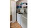 Laundry room with washer, dryer, and storage shelves at 107 Oak Park Dr, Benson, NC 27504