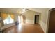 Bright living room featuring wood floors, vaulted ceilings, and ample windows with light-filtering curtains at 107 Oak Park Dr, Benson, NC 27504