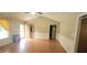 Open living space featuring wood floors, vaulted ceilings, and ample windows with light-filtering curtains at 107 Oak Park Dr, Benson, NC 27504